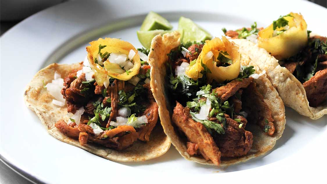 Tacos al pastor recipe on a white plate