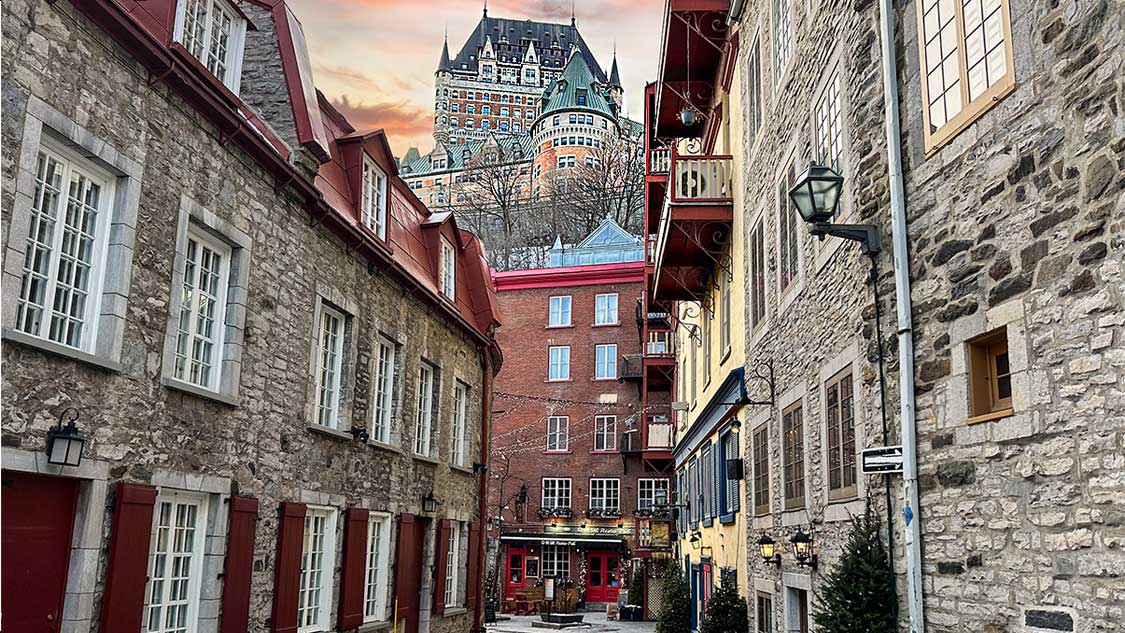 Sunset over the Chateau Frontenac as people explore the best restaurants in Quebec City